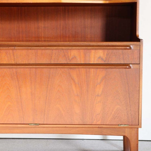 Vintage British mid-century teak cabinet by Macintosh with rich wood grain and sleek tapered legs.