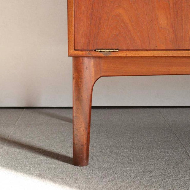 Mid-century British teak cabinet leg with visible wood grain and warm tones by A.H. McIntosh.