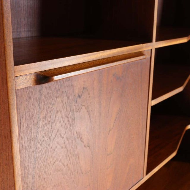 Vintage teak mid-century Macintosh cabinet with smooth wood grain and clean-lined shelf edges.