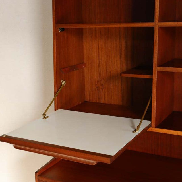 Vintage teak MacIntosh British mid-century cabinet with drop-down white shelf and brass supports.