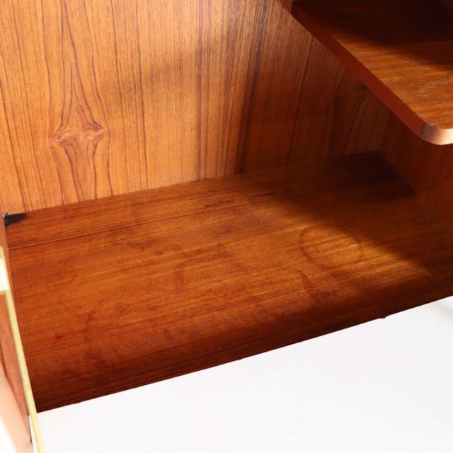 Vintage British mid-century teak cabinet interior showcasing rich wood grain and smooth finish.