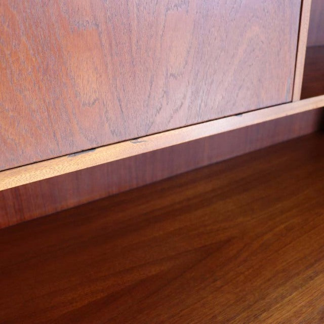 Close-up of vintage British mid-century teak cabinet showcasing rich wood grain and smooth finish.