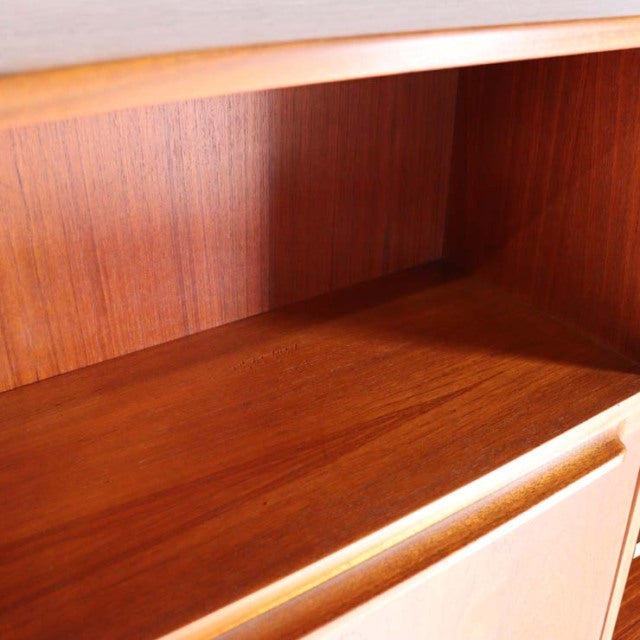 Close-up of vintage teak interior with rich wood grain and warm brown tones from mid-century British Macintosh cabinet.