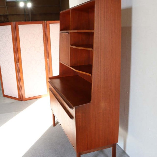 Vintage teak MacIntosh mid-century British cabinet with rich wood grain, open shelving, and slender legs.