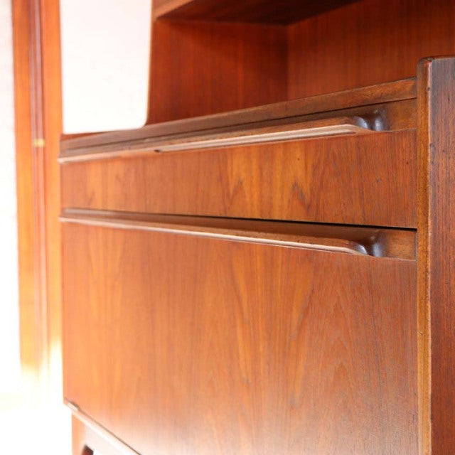 Vintage British mid-century teak cabinet by A.H. McIntosh with rich wood grain and sleek drawer handles.
