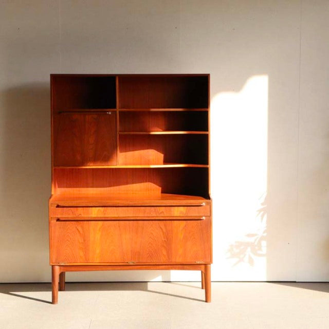 Vintage mid-century teak cabinet by Macintosh, featuring clean lines, open shelves, and tapered legs.