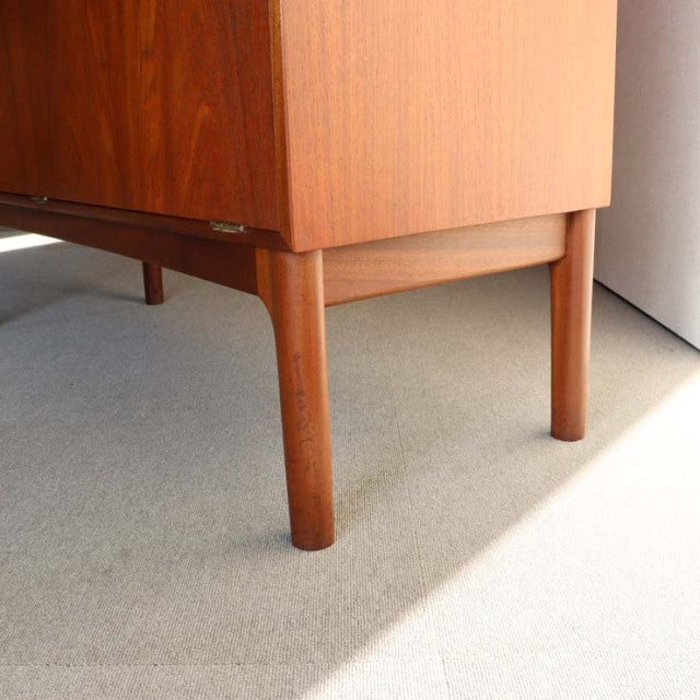 Vintage teak mid-century British Macintosh cabinet leg with visible wood grain and tapered rounded form from Denmark.