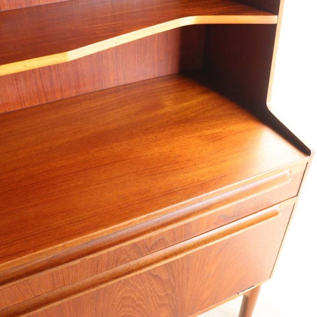 Vintage British mid-century teak cabinet by Macintosh with smooth wood grain and elegant curved shelf edge.