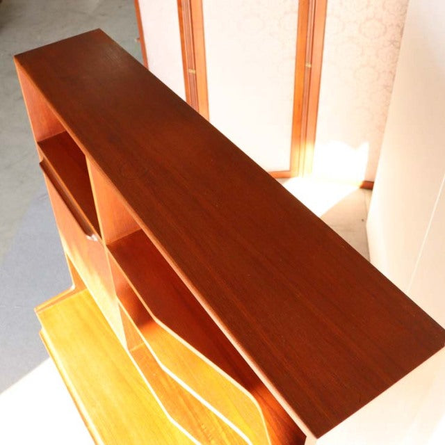 Vintage mid-century British teak cabinet by Macintosh featuring rich wood grain and clean lines with sturdy legs.