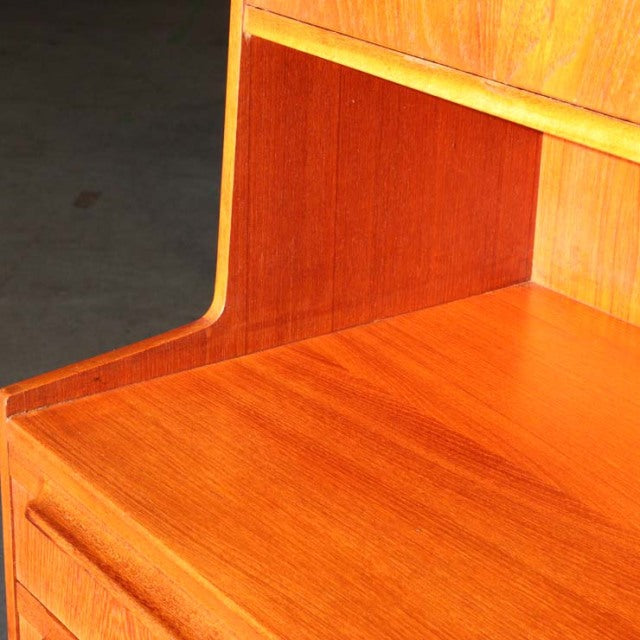 Mid-century British Macintosh teak cabinet corner showing smooth wood grain and rounded edge detail from Denmark vintage.