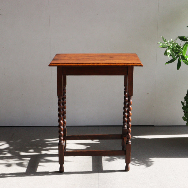 Vintage British mid-century teak side table with rich wood grain and twisted barley twist legs in excellent condition.
