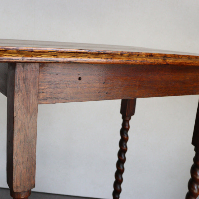 Vintage British mid-century side table in rich teak with visible wood grain, square legs, and twisted barley twist legs.
