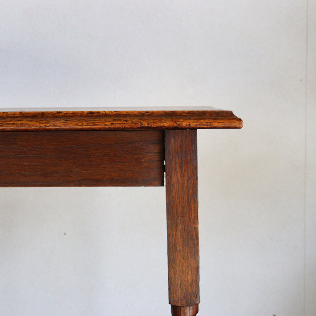Vintage British mid-century teak side table corner showing rich wood grain and sturdy straight leg design.