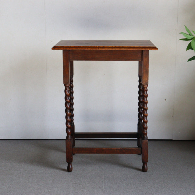 Vintage British mid-century teak side table with rich wood grain and twisted spindle legs, Denmark style.