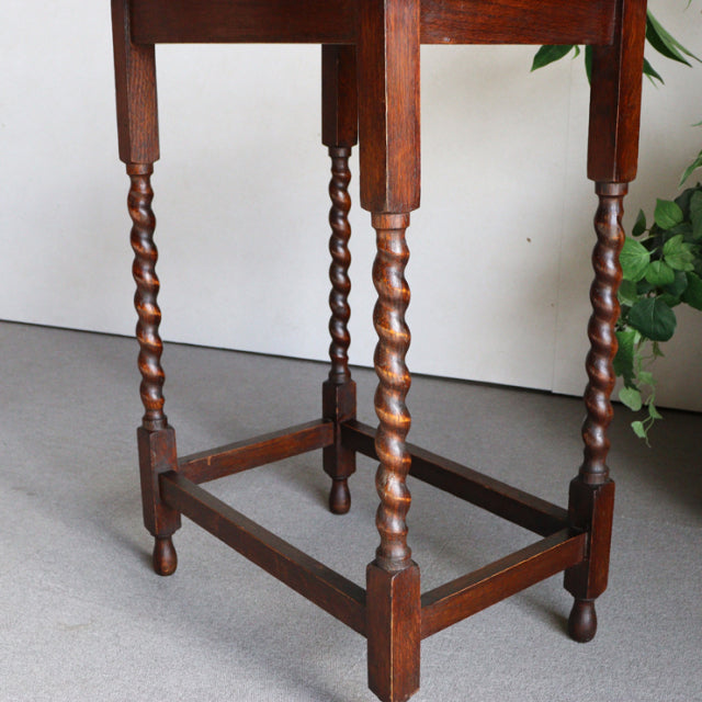 Vintage British oak side table with twisted spindle legs and rich wood grain, mid-century Denmark style.