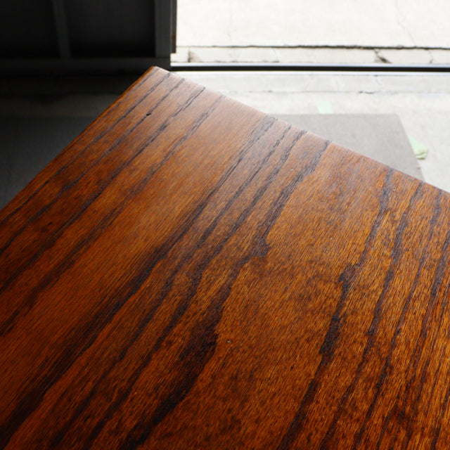 Vintage teak side table with rich wood grain, smooth polished surface, and mid-century British design details.