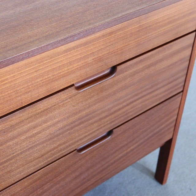 Mid-century vintage teak sideboard by Fyne Ladye, British-Denmark style, showcasing warm wood grain and recessed handle.