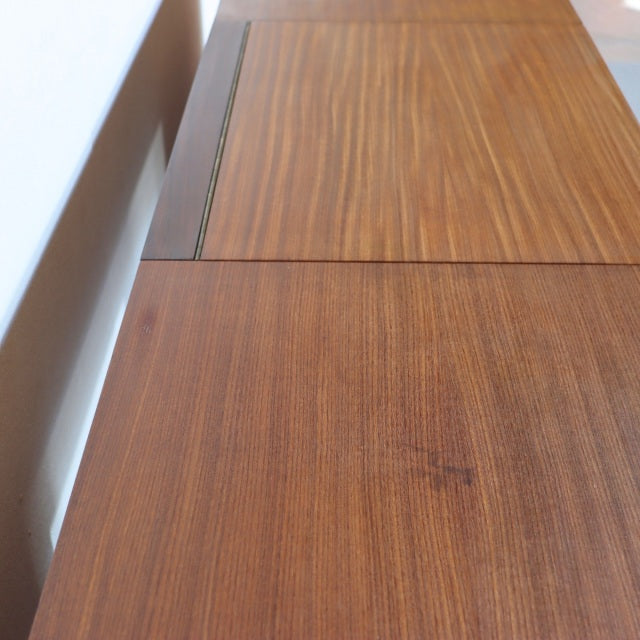 Mid-century teak sideboard with smooth wood grain and clean lines, British design by Fyne Ladye Furniture.