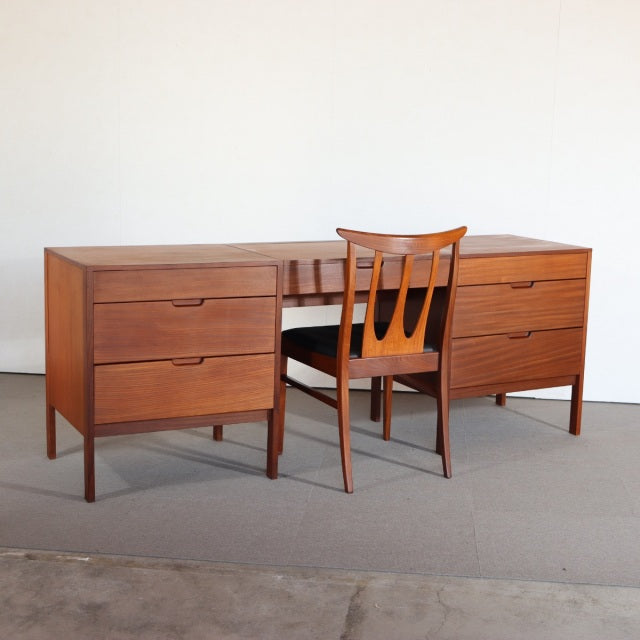 Mid-century British teak sideboard by Fyne Ladye with smooth wood grain, clean lines, and tapered legs, paired with a.