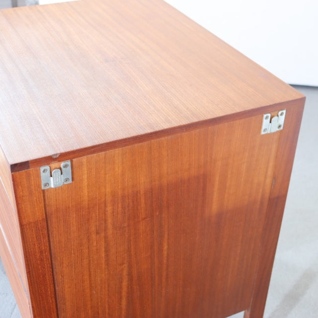 Mid-century British teak sideboard by Fyne Ladye with rich wood grain and metal corner hardware.