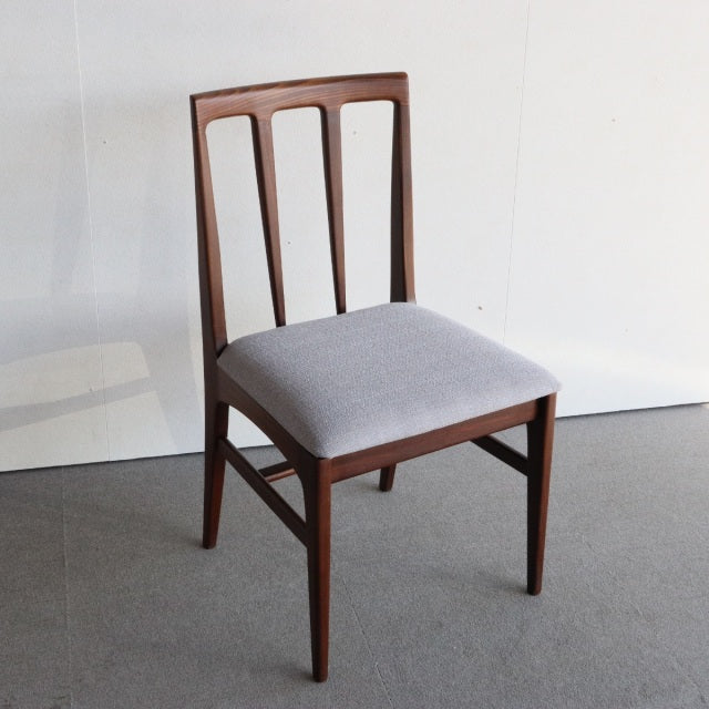 Vintage teak dining chair by Younger with British mid-century design, Danish-inspired clean lines, and gray upholstered seat.