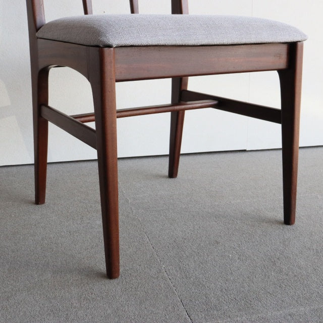 Mid-century British teak dining chair by Younger, sleek tapered legs and gray upholstered seat.