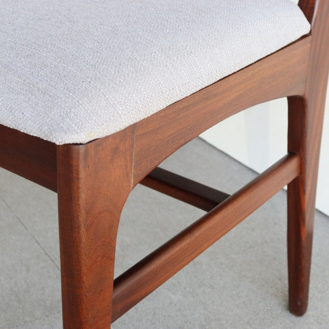 Mid-century British vintage teak dining chair by Younger, clean lines, visible wood grain, light beige fabric seat.