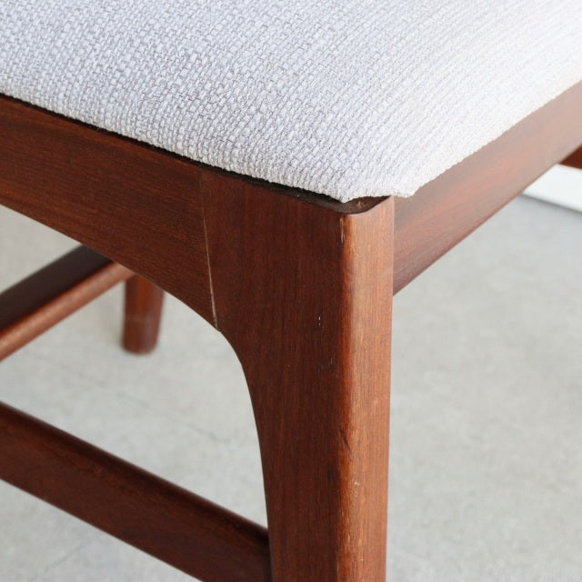 Vintage teak dining chair corner showing smooth wood grain and clean mid-century British design by Younger John Herbert,.