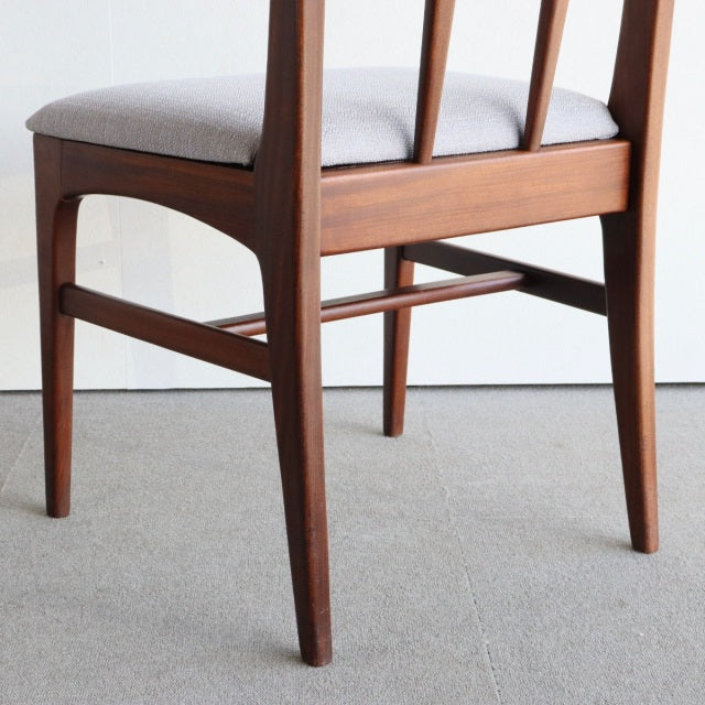 Mid-century British vintage teak dining chair by Younger, slender tapered legs, smooth wood grain, gray upholstered seat,.