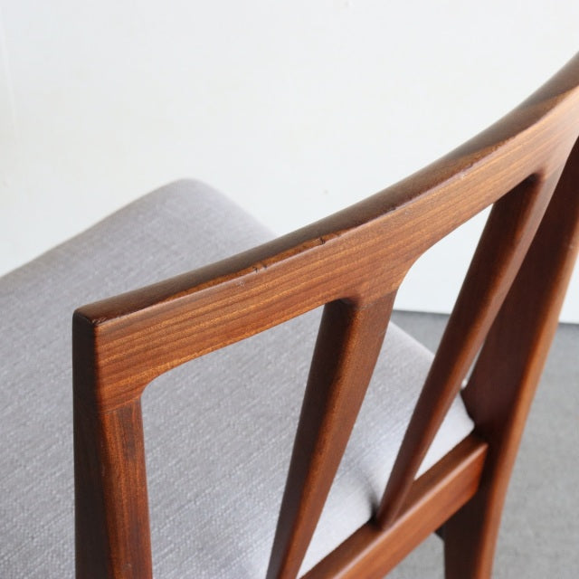 Mid-century teak dining chair by Younger with sleek British design, smooth grain, and grey upholstered seat.
