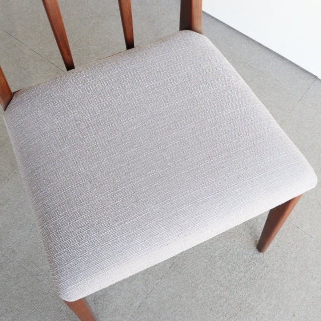 Mid-century vintage teak dining chair by Younger with beige cushioned seat and tapered wooden legs.