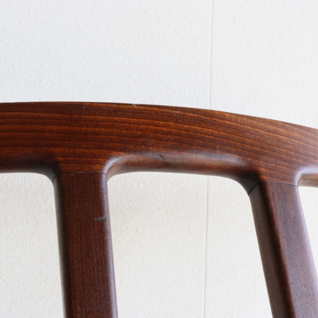 Close-up of vintage teak dining chair backrest by British Younger, mid-century Denmark design with smooth wood grain and.