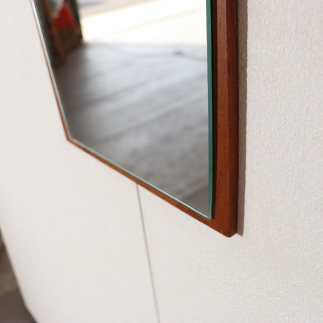 Vintage teak wall-mounted mirror from mid-century Denmark with clean lines and warm wood grain frame.