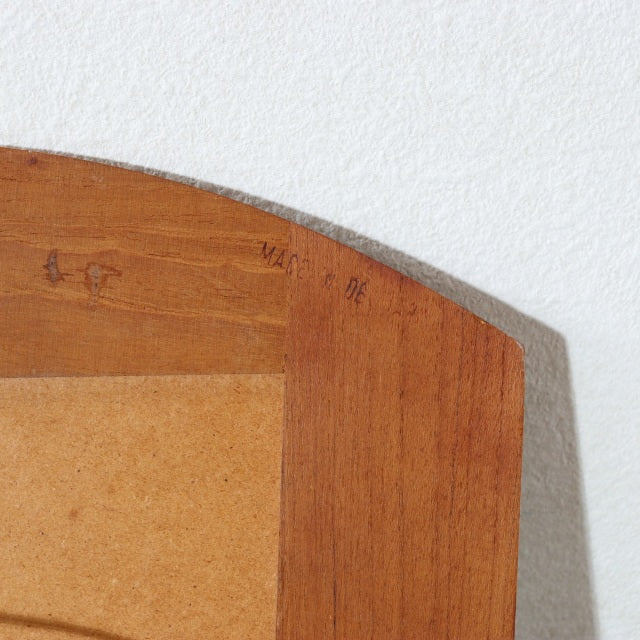 Close-up of vintage Danish teak wall mirror corner with smooth wood grain and mid-century craftsmanship details.