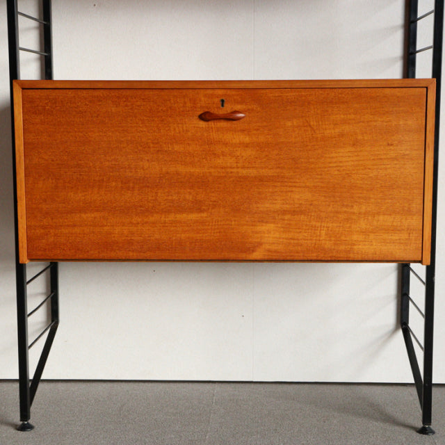 Vintage teak Ladderax unit shelf with smooth wood grain, mid-century British design, black metal frame legs.