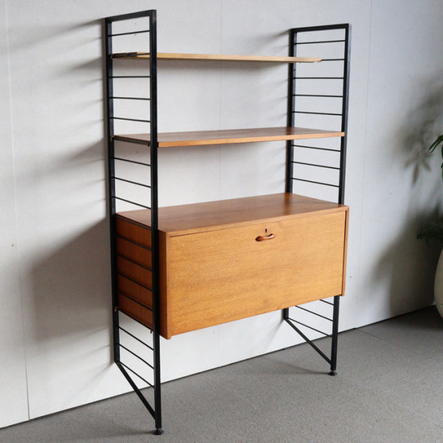 Vintage mid-century Ladderax shelving unit by Staples with black iron frame and teak wood shelves, featuring visible wood.