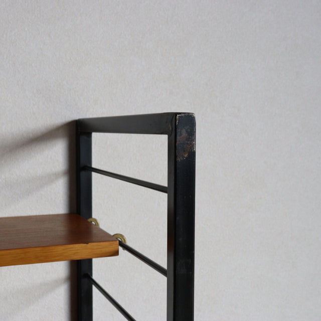 Vintage Ladderax unit shelf by Staples, British mid-century design with teak shelf and black metal frame showing wood grain.