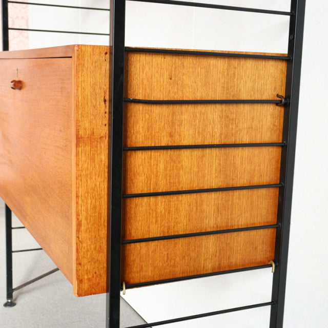 Vintage teak Ladderax shelving unit by British brand Staples, mid-century Denmark design with black metal frame and warm.
