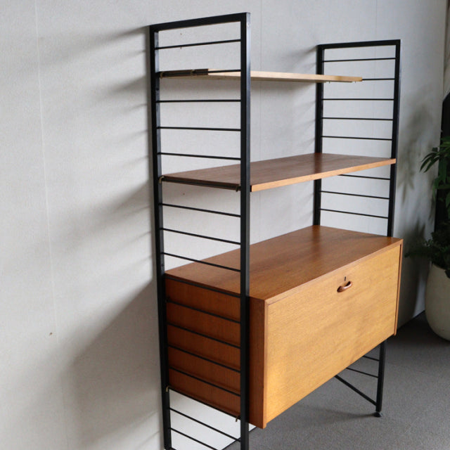 Vintage teak Ladderax shelving unit by Staples, British mid-century design with black metal frame and wood grain shelves,.
