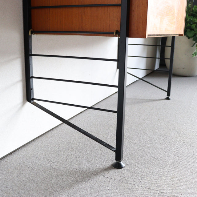 Vintage British Ladderax shelving unit with teak panels, black iron frame, and mid-century Danish design.