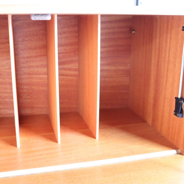 Vintage British Ladderax shelving unit in warm teak with visible wood grain and clean mid-century lines.