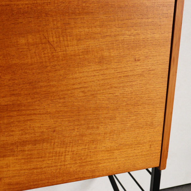 Mid-century vintage teak Ladderax shelving unit with sleek wood grain and black metal legs from British brand Staples.