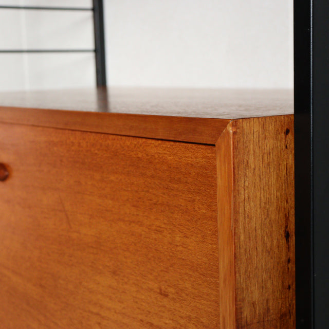 Vintage teak Ladderax unit shelf by Staples, showcasing mid-century British design with warm wood grain and black metal.