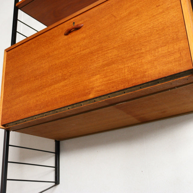 Vintage mid-century teak Ladderax shelving unit by British Staples with sleek black metal frame and visible wood grain.