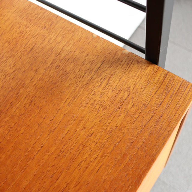 Close-up of vintage teak wood grain top with smooth finish on British mid-century Ladderax shelving unit by Staples,.