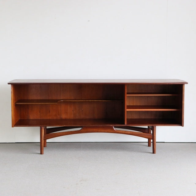 Mid-century British teak sideboard by Dalescraft with rich wood grain, open shelves, and tapered legs with curved support.