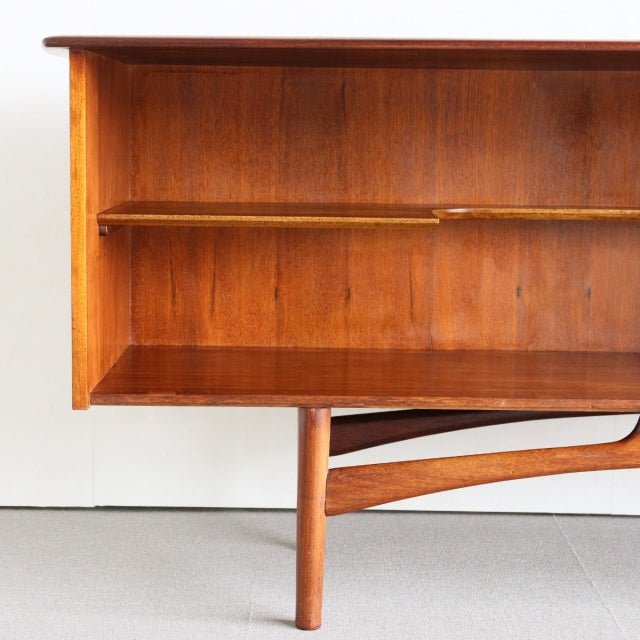 Mid-century British vintage teak sideboard by Dalescraft with prominent wood grain, open shelving, and tapered legs.