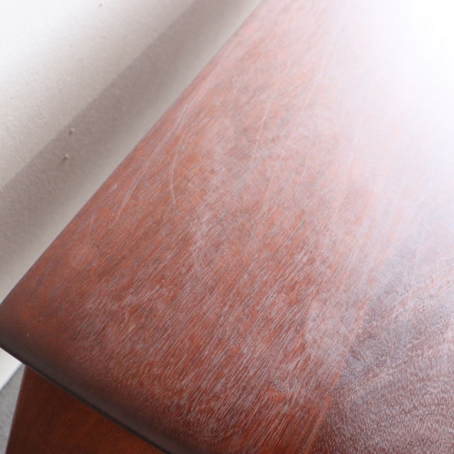 Close-up of vintage teak sideboard top showcasing rich wood grain and mid-century British craftsmanship.
