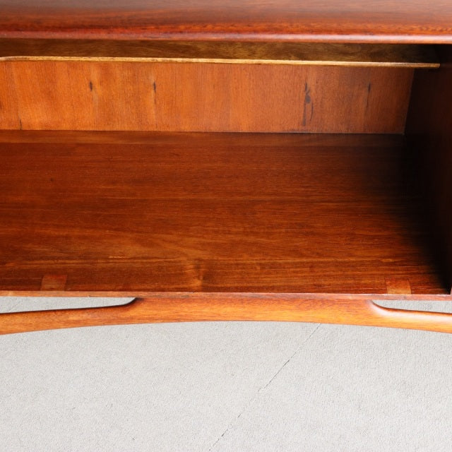 Open compartment of vintage teak mid-century British Dalescraft sideboard showing rich wood grain and smooth interior finish.