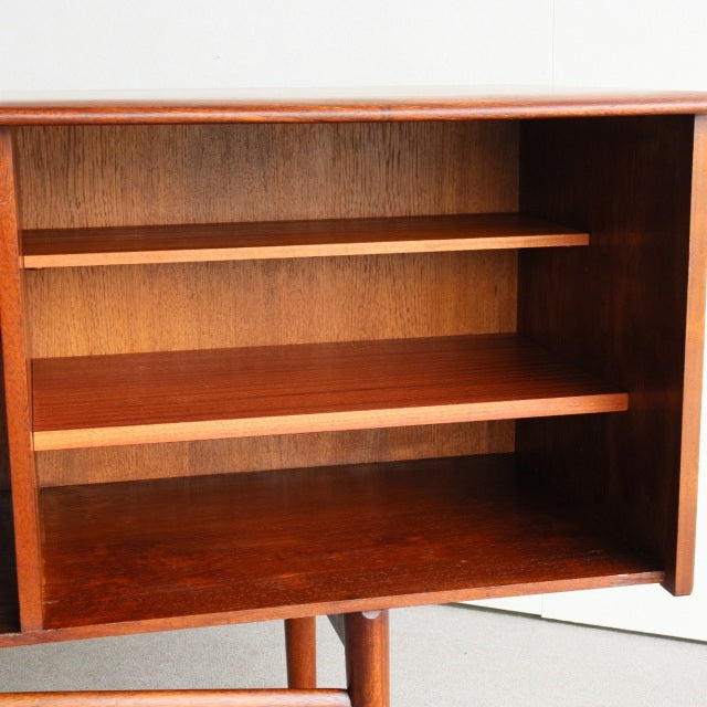 Open teak sideboard with visible wood grain, mid-century British design by Dalescraft, featuring two interior shelves and.